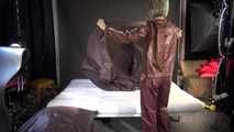 Watching sexy Sonja wearing a brown shiny nylon rainwear combination while preparing her bed (Video)