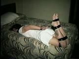 HEATHER IS F0RCED TO TAPE UP HER LEGS AND BARE FEET & IS THEN PANTY STUFFED AND WRAP GAGGED THEN HOG-TIED WITH TAPE ON THE BED (D52-14)