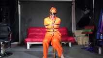 Sexy Pia wearing an oldschool orange shiny nylon rain pants and rain jacket being tied and gagged with belts and a ballgag on a chair (Video)