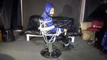 Watching sexy Sandra wearing a sexy blue shiny nylon rainpants and a blue down jacket being tied and gagged and hooded with ropes on a hairdressers chair covered with a rain cape (Video)