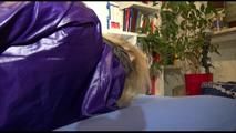 Pia tied and gagged on a blue sofa wearing a down skirt and a shiny nylon rain jacket (Video)
