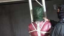 Ayana in a shiny nylon red rainsuit and a see through PVC Rainjacket, tied gagged, hooded and vibed