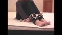 Satisfaction Girl - Barefoot brunette beauty uses cuffs and tape gag (video)