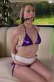 Sophie bound and gagged in a purple shiny wetlook Bikini