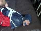 Watch Sandra hogtied and pantygagged in her shiny nylon Rainwear trying to free herself.