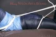 PIA tied with ropes on the sofa, gagged with a cloth gag wearing a sexy blue oldschool shiny nylon rain suit (Pics)