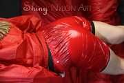 Watching sexy Sandra during her selfbondage action with cuffs in a red shiny nylon Crazy Sensations Chillshorty and a shiny nylon rain jacket in red (www.crazysensations.com). Buy the original Short (used) from us.