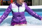 Watching sexy Mara wearing a sexy purple downskirt and a purple downjacket lolling in the swimming pool (Pics)