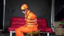 Sexy Pia wearing an oldschool orange shiny nylon rain pants and rain jacket being tied and gagged with belts and a ballgag on a chair (Video)