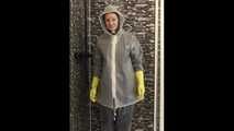 Lady in AGU rainwear and transparent raingear under the shower