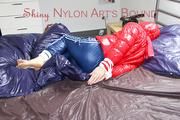 Mara tied and gagged on bed wearing a sexy shiny red down jacket and a blue rain pants (Pics)