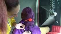 Watching sexy Sandra wearing hot purple shiny nylon rainwear with rubber boots being tied, gagged and hooded from Stella wearing a sexy yellow shiny nylon rainwear with high heels rubber boots (Video)