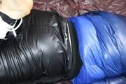 Jill hooded, bound and gagged in sexy shiny black rainwear and blue down jacket 