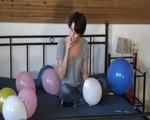 Smoking teen plays with many balloons