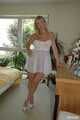 Busty blonde Marlen posing in a white negligee in the bedroom