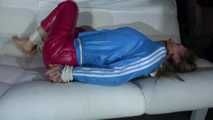 Sexy Sandra being tied and gagged on a sofa with ropes and a ball gag wearing a supershiny sexy red rain pants and a lightblue rain jacket (Video)