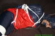 Watch Sandra bound gagged wearing her shiny nylon Rainwear