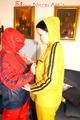 Jill and a friend of her pplaying with eachother wearing yellow and red shiny nylon rainwear (Pics)