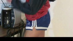 Alina sitting in front of the PC, on a sofa and ind the kitchen wearing different kind of sexy shiny nylon shorts and rain jackets (Video)