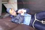 PIA tied with ropes on the sofa, gagged with a cloth gag wearing a sexy blue oldschool shiny nylon rain suit (Pics)