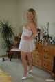 Busty blonde Marlen posing in a white negligee in the bedroom