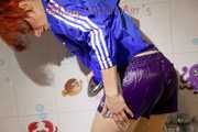 Sonja taking a shower wearing a very hot purple shiny nylon shorts and a blue rain jacket (Pics)