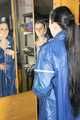 Lucy wearing sexy blue shiny nylon rainwear cleaning the mirror (Pics)