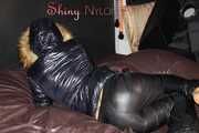 Watching Sandra wearing a sexy shiny nylon down pants and a sexy down jacket with coat lolling and posing for you on a sofa (Pics)