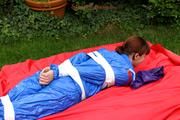 Nicole in an blue sauna suit tied and gagged in the garden (Pics)