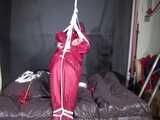 Watch Sandra beeing bound gagged and pantyhooded in her shiny nylon Rainwear