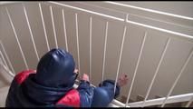 Jill tied, gagged and hooded with a bar on the stairway wearing a sexy oldschool downwear combination (Video)