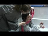 Simone  with an shiny silver PVC sauna suit tied and gagged by Sophie in an bath tub (Video)