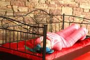 Mara tied and gagged on a princess bed in an old cellar wearing supersexy shiny pink downwear (Pics)