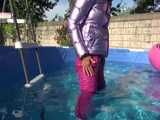 Watch Sandra enjoying her shiny nylon Downwear at a warm Summer Day in the Garden and in the Pool