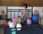 Smoking teen plays with many balloons