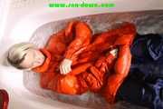 SEXY SONJA wearing a black shiny nylon rain pants and an orange big downjacket enjoying a bath (Pics)