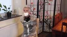 Miss Francine is bound and gagged in a nice short PVC dress covered with a transparent raincoat