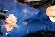 Pie tied and gagged with a bar on a bed wearing sexy blue shiny nylon AGU rainwear combination (Pics)