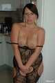 Chubby benita posing in a black bodystocking in the kitchen