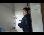 Jill wearing a sexy red shiny nylon shorts and a black rain jacket while taking a shower and play with babyoil (Video)