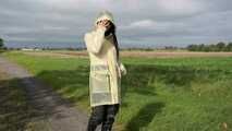 Miss Amira on the road in a transparent Schmuddelwedda raincoat, rainpants and rubber boots