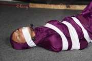 Sexy Sandra being tied, gagged and hooded with tape on the floor wearing a supersexy purple rain overall (Pics)