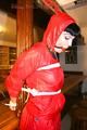 Jill tied and gagged on a pillar wearing a shiny red rainwear (Pics)