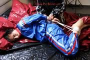 Simone tied and gagged by Sophie in bed wearing a blue and black shiny PVC sauna suit (Pics)