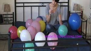 Smoking teen plays with many balloons