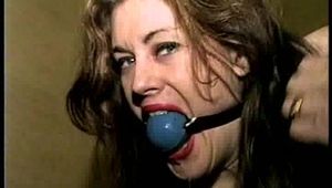 26 YEAR OLD RIVER IS BALL-GAGGED, WIDE EYED DROOLING, MOUTH STUFFED, CLEAVE GAGGED, OTM GAGGED & HANDGAGGED (D66-16)