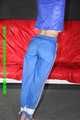 Sexy Sonja being tied and gagged overhead with ropes wearing a sexy blue shiny nylon pants and a jacket (Pics)