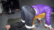 Watching Sonja wearig a sexy blue rainpant and a purple down jacket being tied, gagged and hooded on a stool with ropes and a cloth gag (Video)