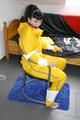 Jill tied and gagged on a chair wearing a yellow rainsuit and coveres with an yellow raincoat with two hoods (Pics)