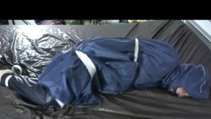 01:50 Min. video with Simone tied and gagged in a shiny nylon rainsuit and a nylon cape